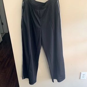 Black joggers with white side stripe.